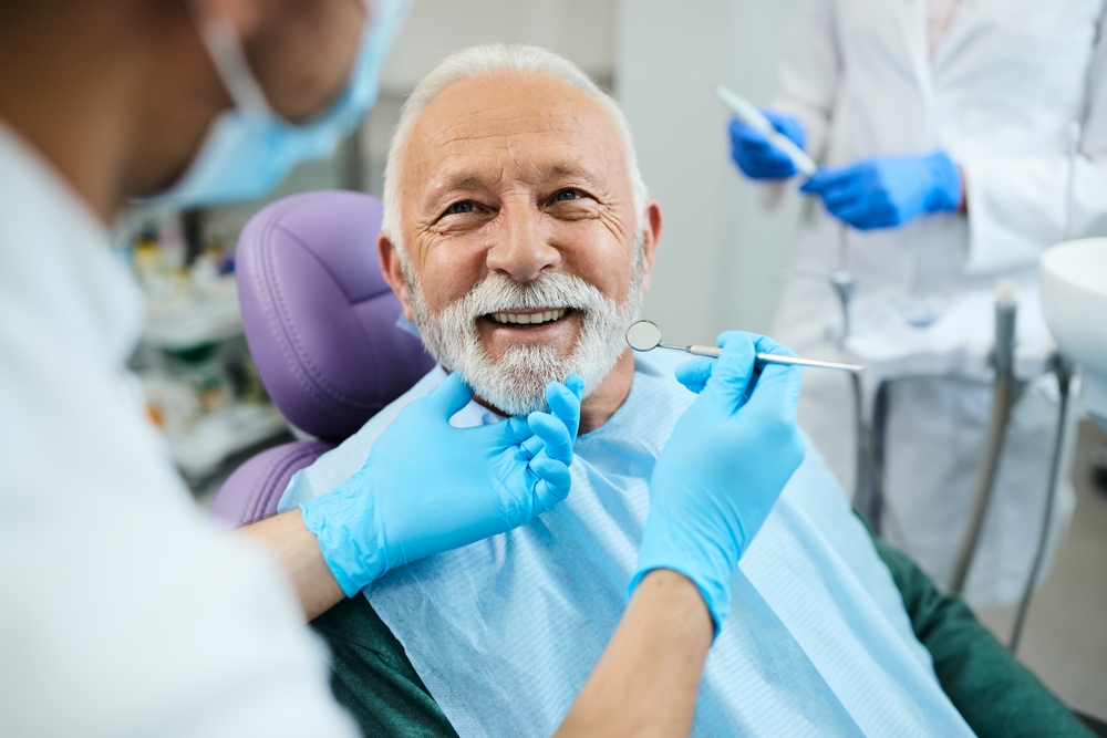 Happy,Mature,Man,During,Teeth,Check-up,At,Dental,Clinic.